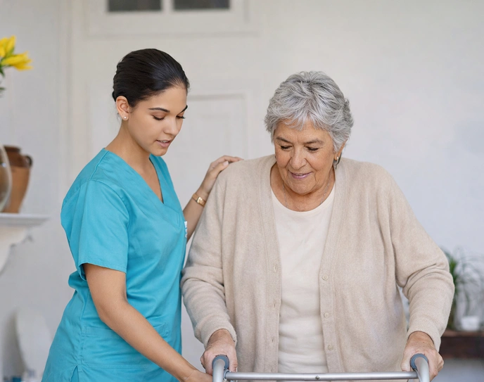 Caregiver assisting an elderly woman using a walker at home.