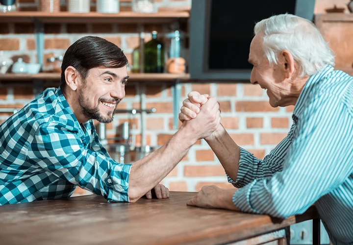 Caregiver providing companionship and support to a senior man at home